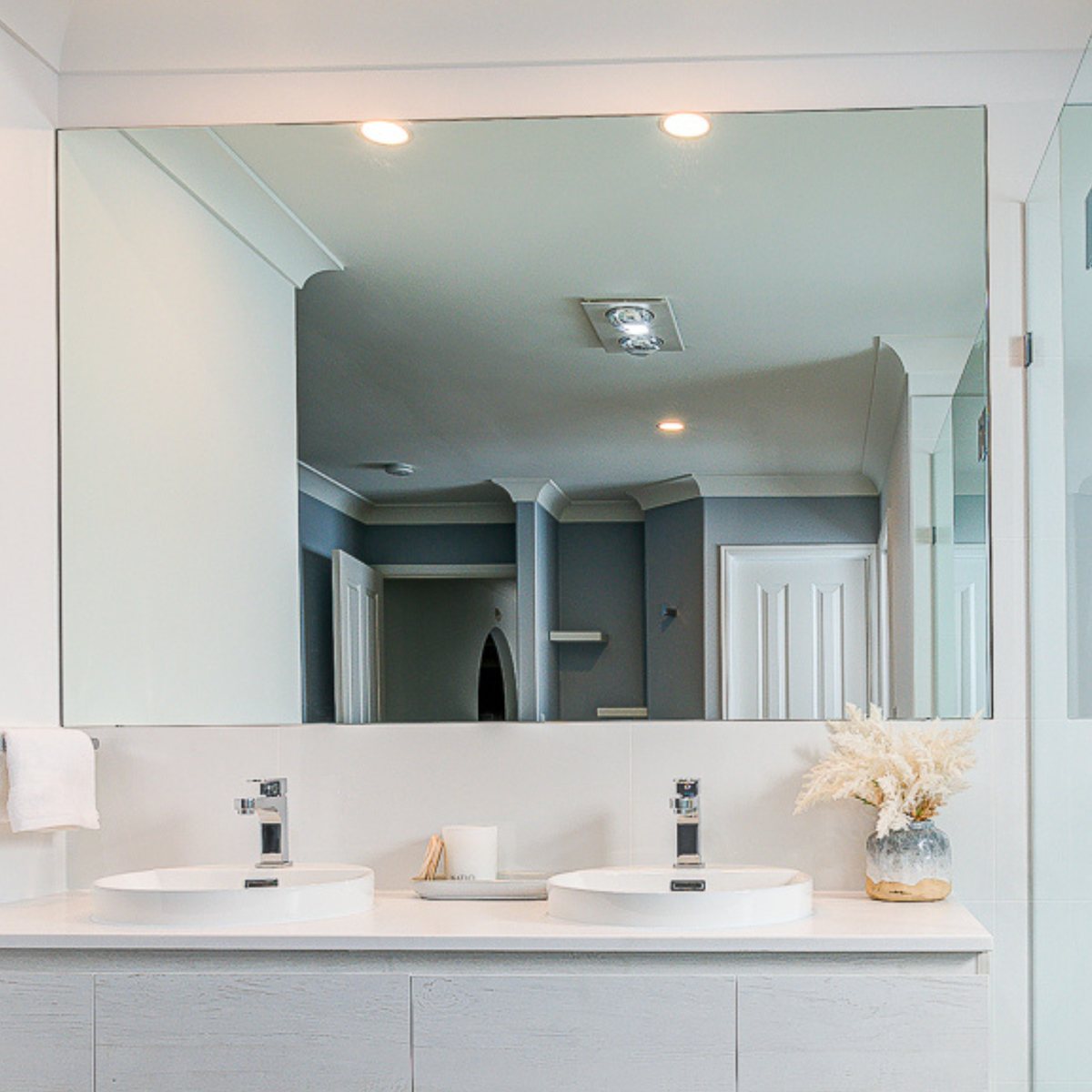 Rectangle polished edge mirror above a double-basin vanity