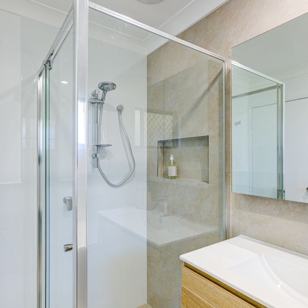 Semi framed shower screen with a shower rail and tiled niche